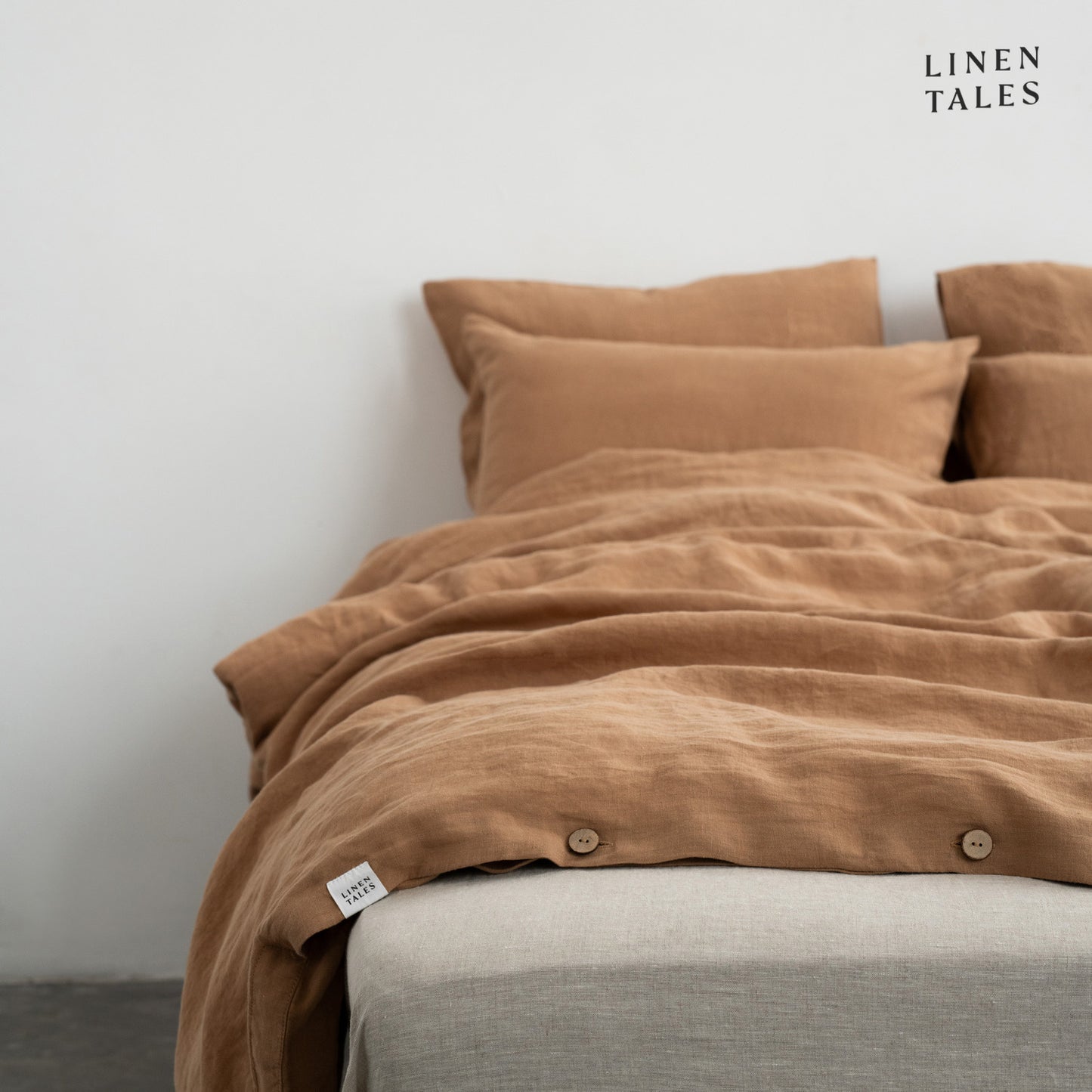 Layered look of Camel linen duvet set with coordinating sheet, offering effortless comfort and timeless style.