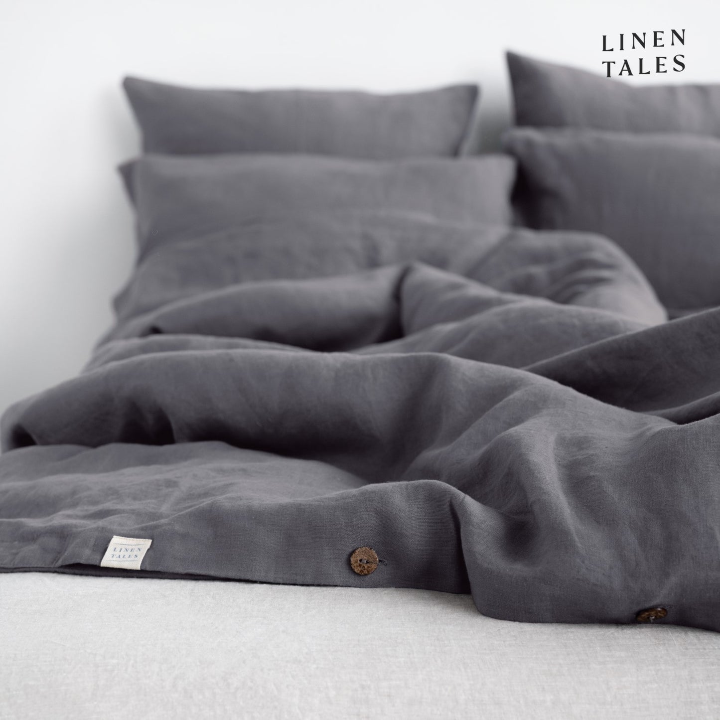 Softly ruffled Dark Grey linen duvet cover and pillowcase, highlighting relaxed elegance and breathable fabric.