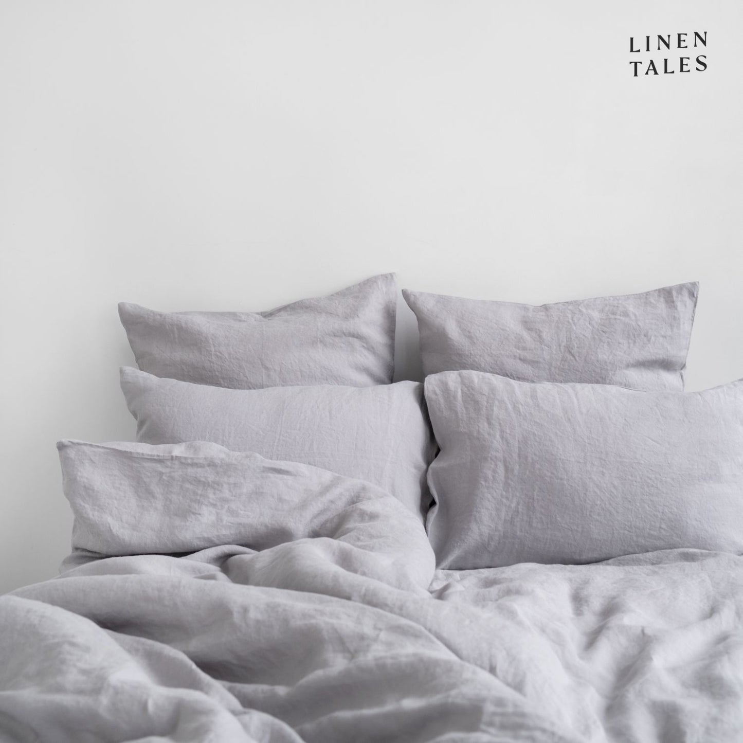 Softly ruffled Light Grey linen duvet cover and pillowcase, highlighting relaxed elegance and breathable fabric.