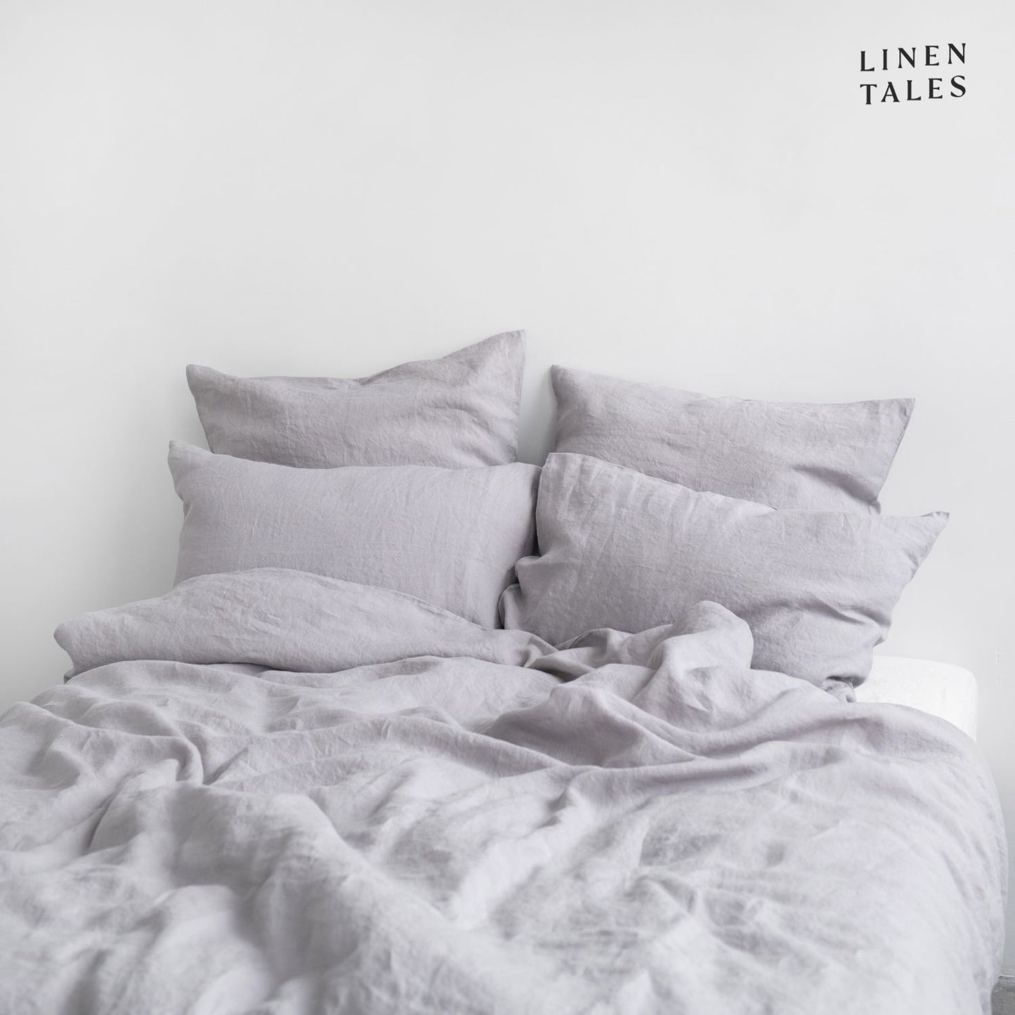 Beautifully made bed featuring Light Grey linen duvet set and pillows, styled for luxurious comfort and breathable relaxation.