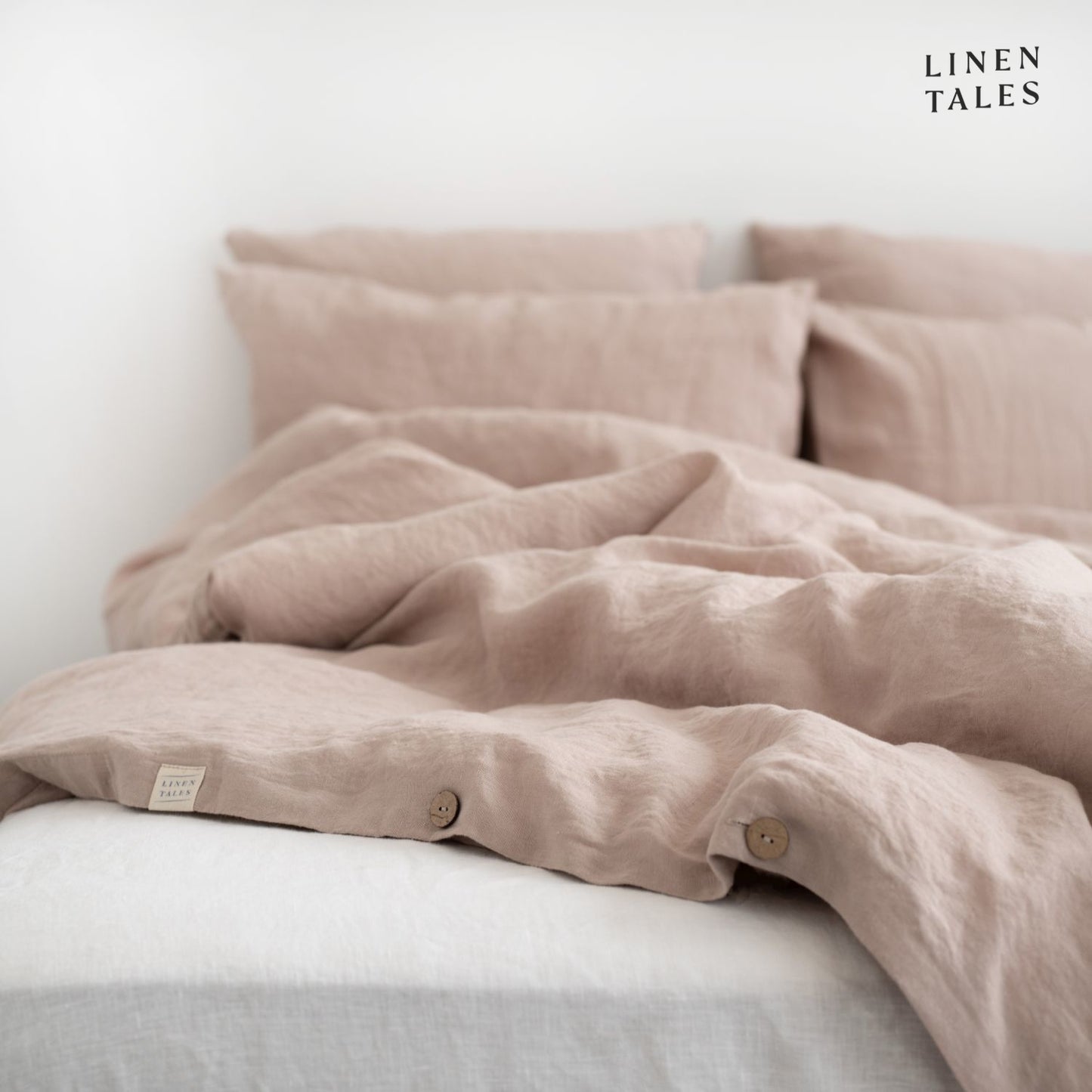 Fine edge stitching and branded Linen Tales tag on Portobello linen duvet cover, showcasing craftsmanship and premium quality.