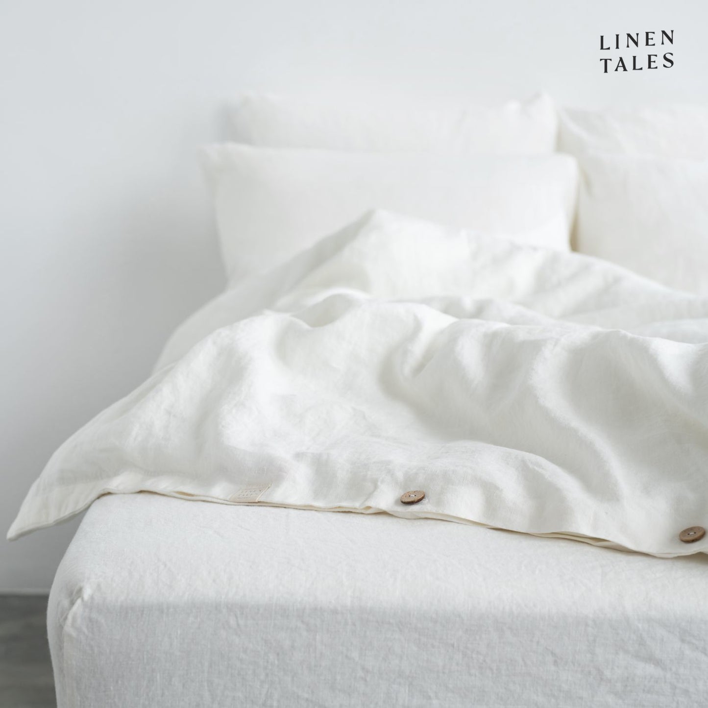 Layered look of White linen duvet set with coordinating sheet, offering effortless comfort and timeless style.