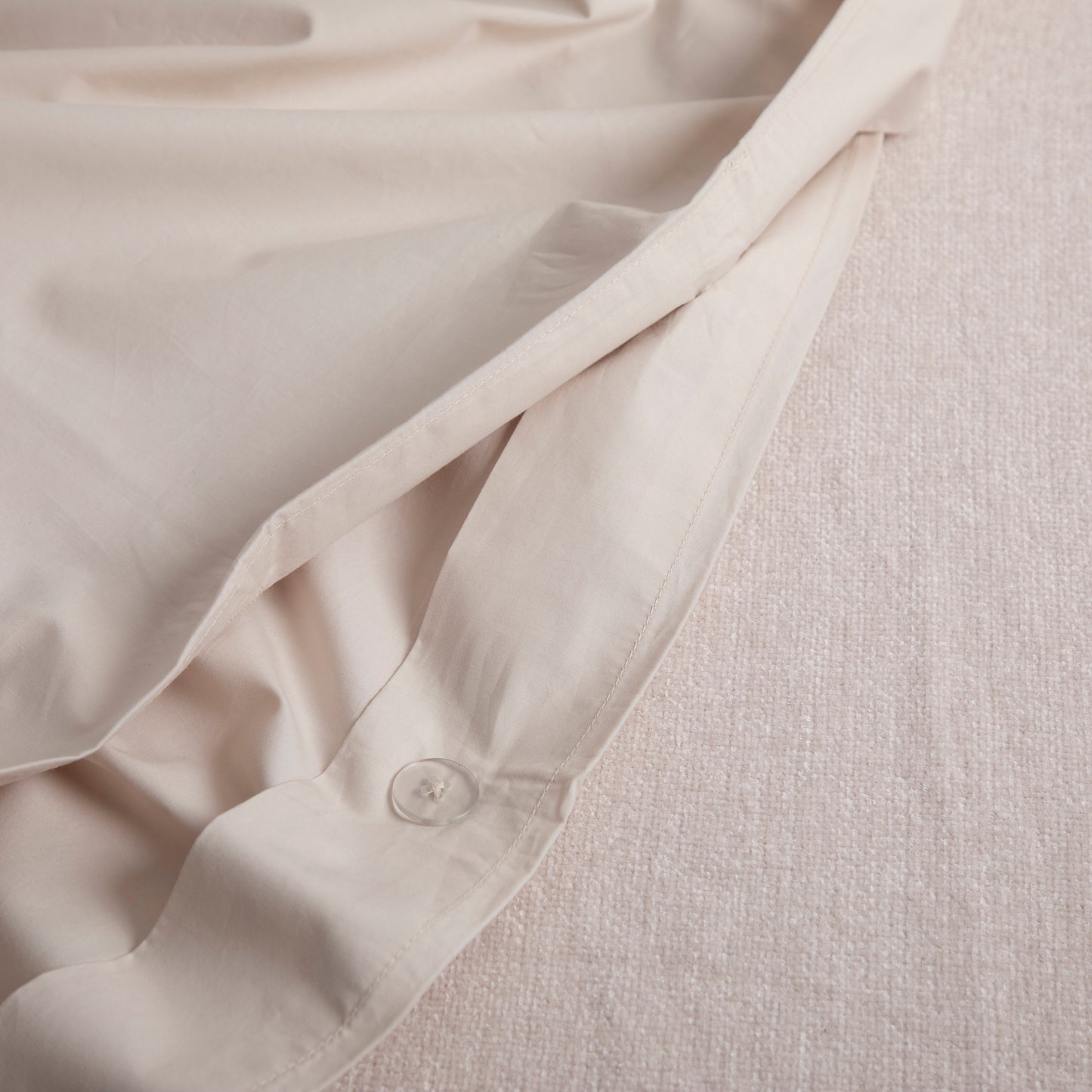 Close-up of a driftwood coloured Linen Bay duvet with a hidden button closure on a light gray background – Linen Bay UK