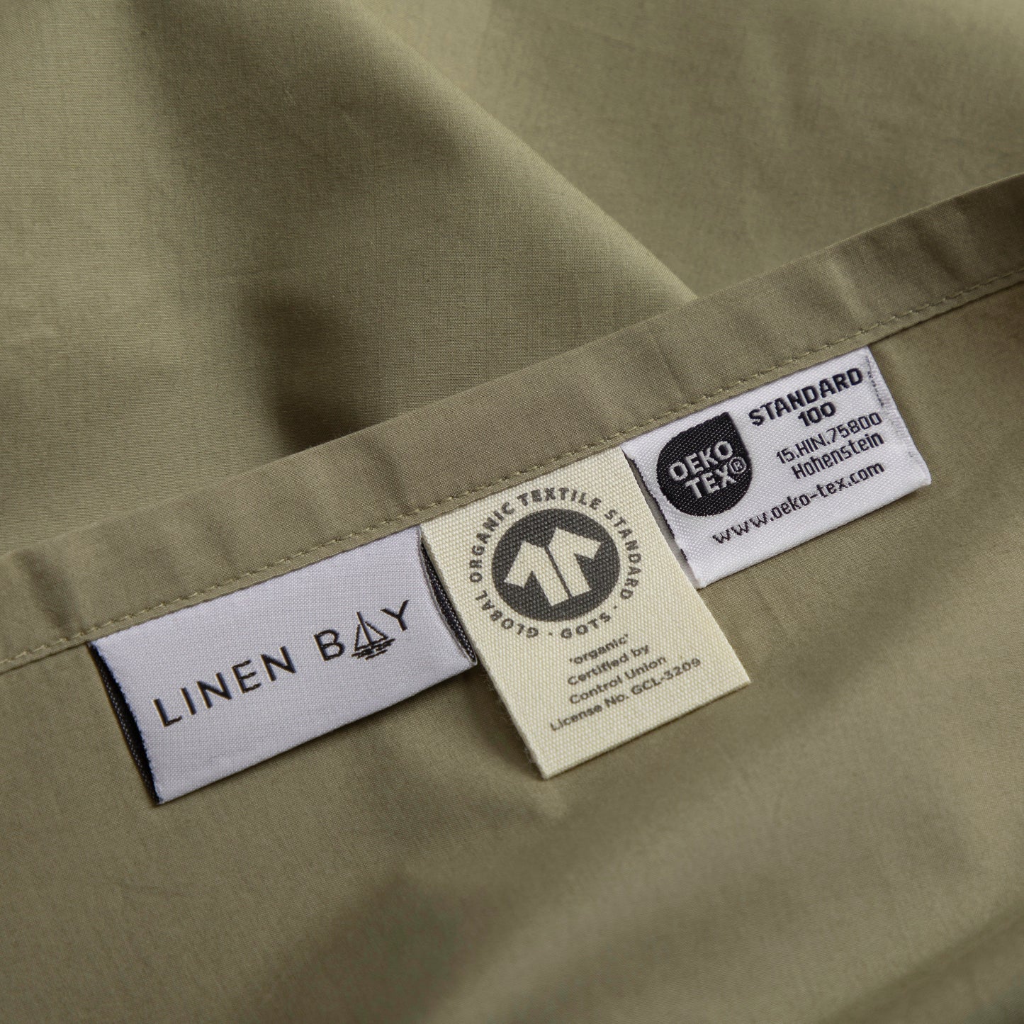 Close-up of Linen Bay labels on a fabric background