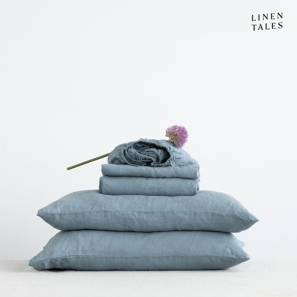 Imagine these beautifully draped linen sheets in Blue Fog with matching pillowcase, styled on a bed – crafted for comfort, elegance, and natural breathability.