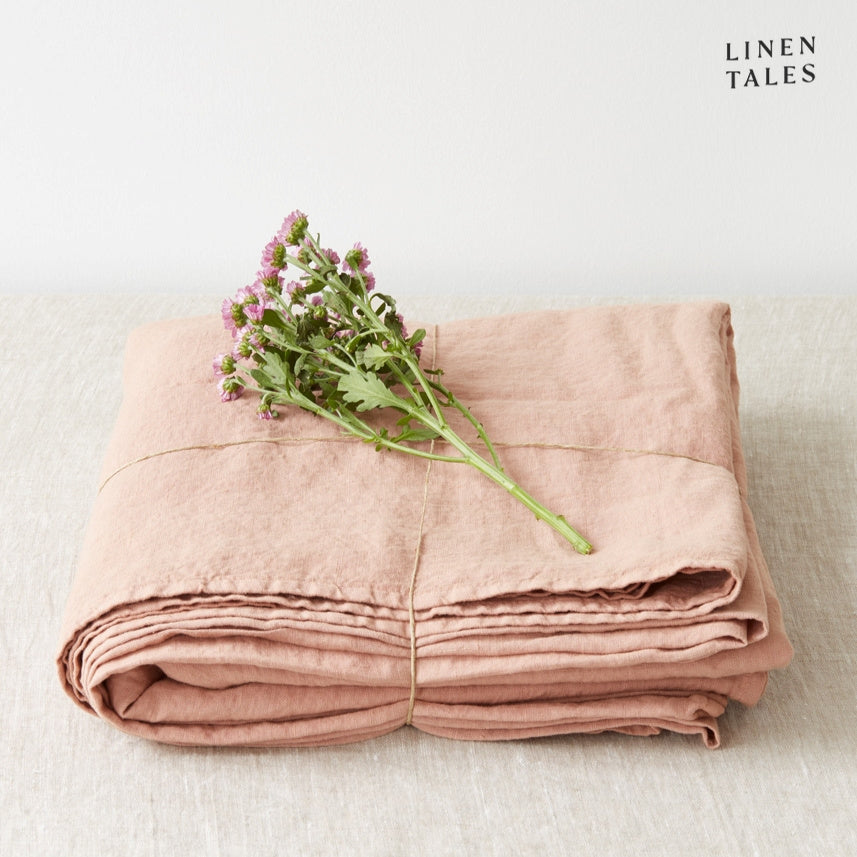 A folded fitted 100% pure linen flat sheet in creamy cafe creme, exuding warmth and sophistication.