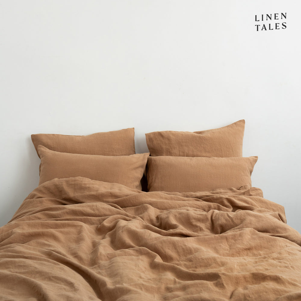 
                  
                    Beautifully made bed featuring Camel linen duvet set and pillows, styled for luxurious comfort and breathable relaxation.
                  
                