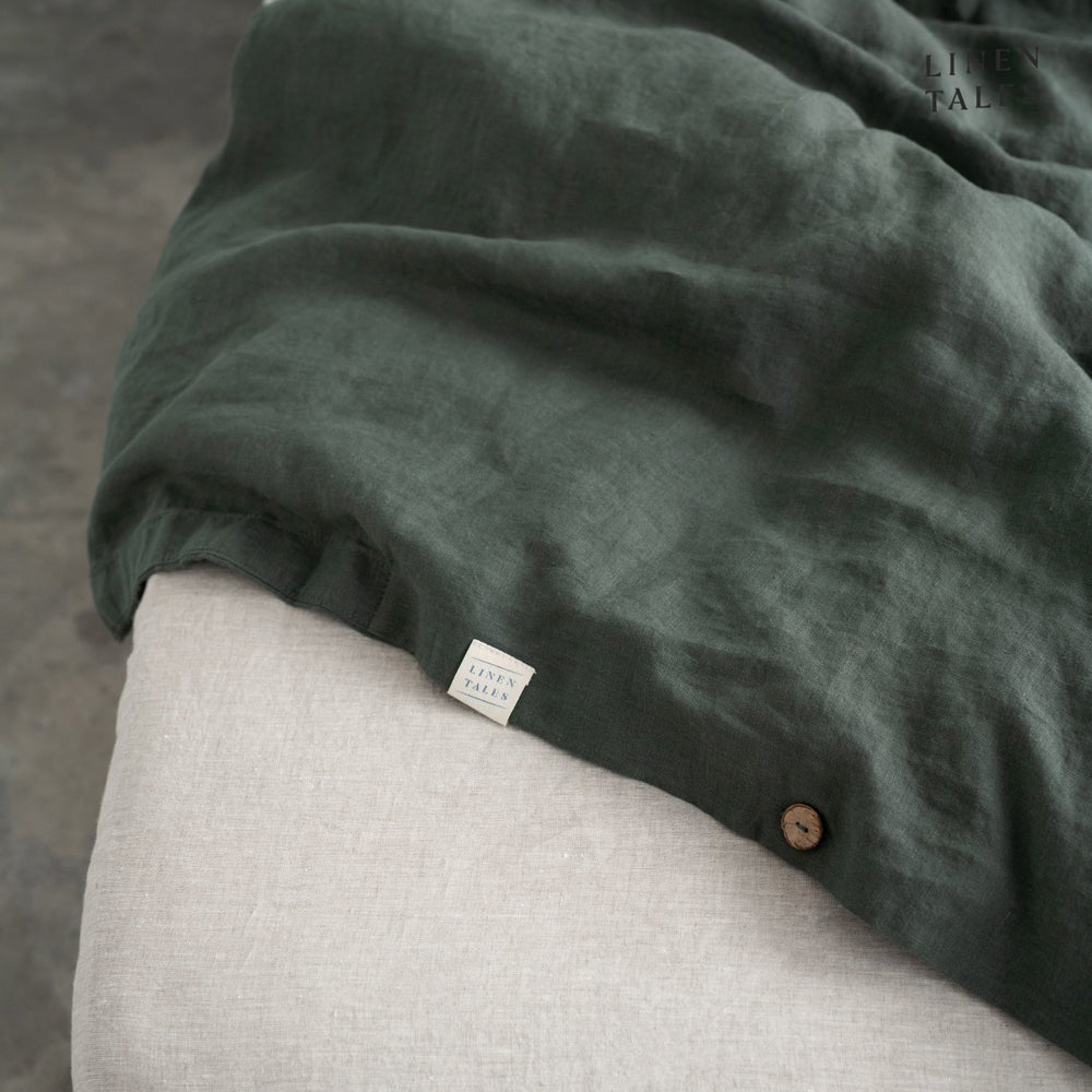 
                  
                    Fine edge stitching and branded Linen Tales tag on Forest Green linen duvet cover, showcasing craftsmanship and premium quality. 
                  
                