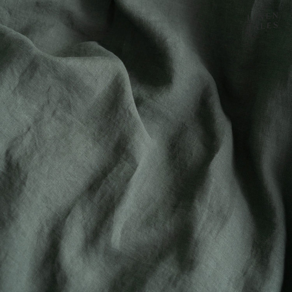 
                  
                    Textured close-up of Forest Green linen fabric, showcasing natural fibers, softness, and breathable weave. 
                  
                