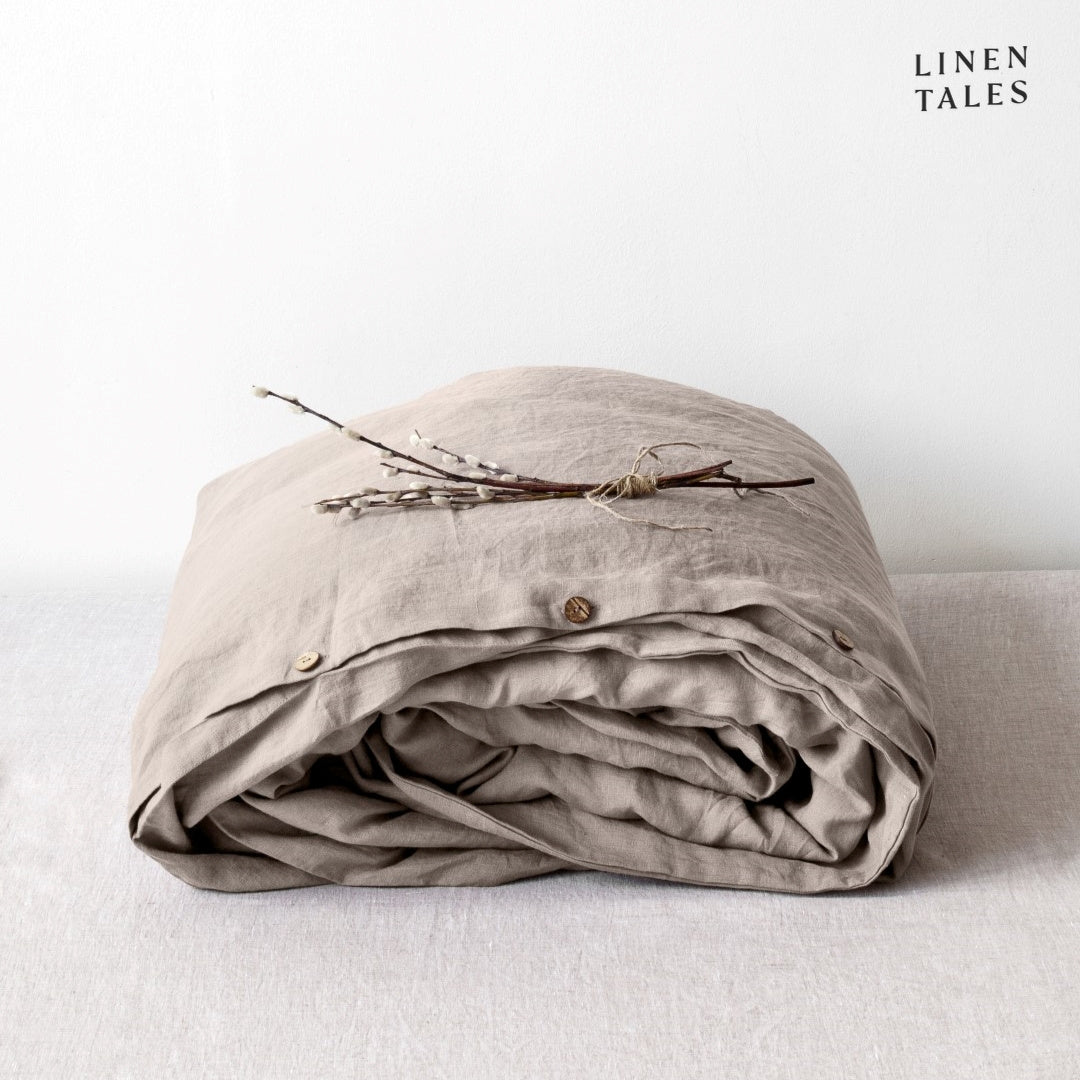 A folded 100% pure linen duvet cover in earthy portobello brown, offering depth and rustic elegance