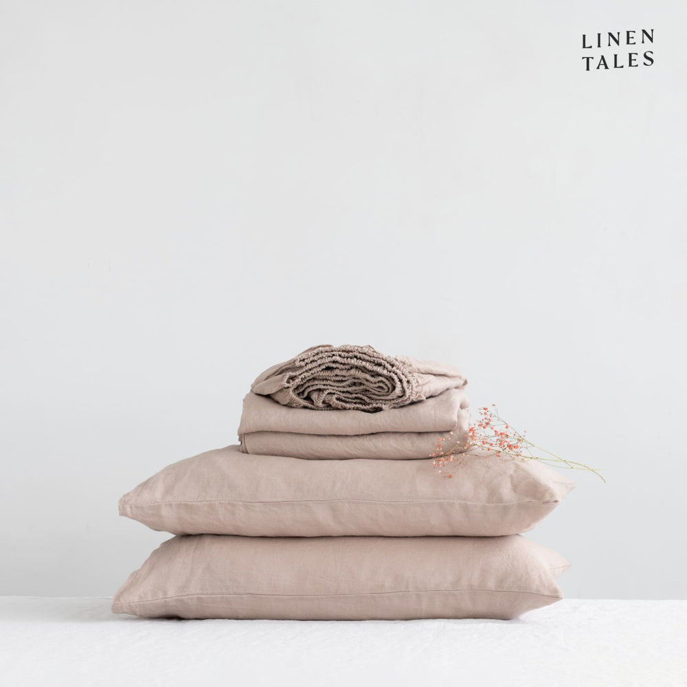 Close-up of 100% linen bedding in Portobello, showcasing the soft texture of the flat sheet, fitted sheet, and pillowcase – breathable and timeless.