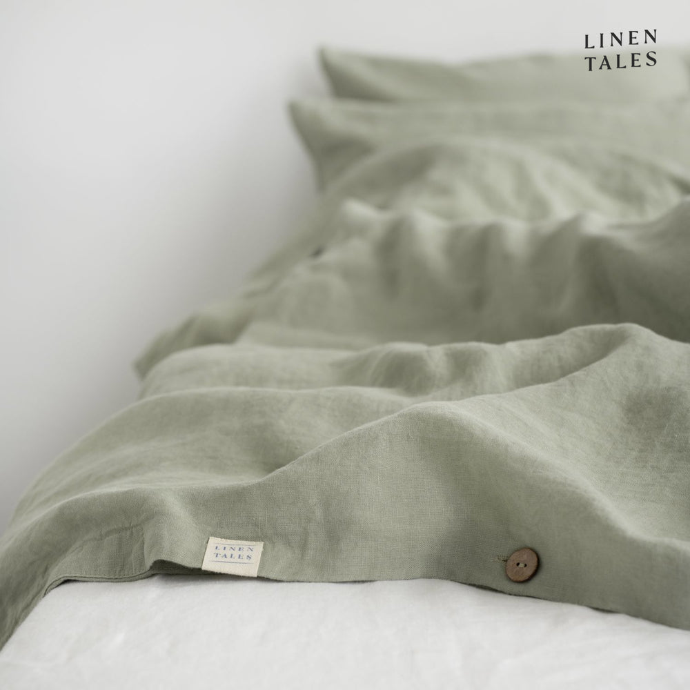 Fine edge stitching and branded Linen Bay tag on Sage linen duvet cover, showcasing craftsmanship and premium quality.