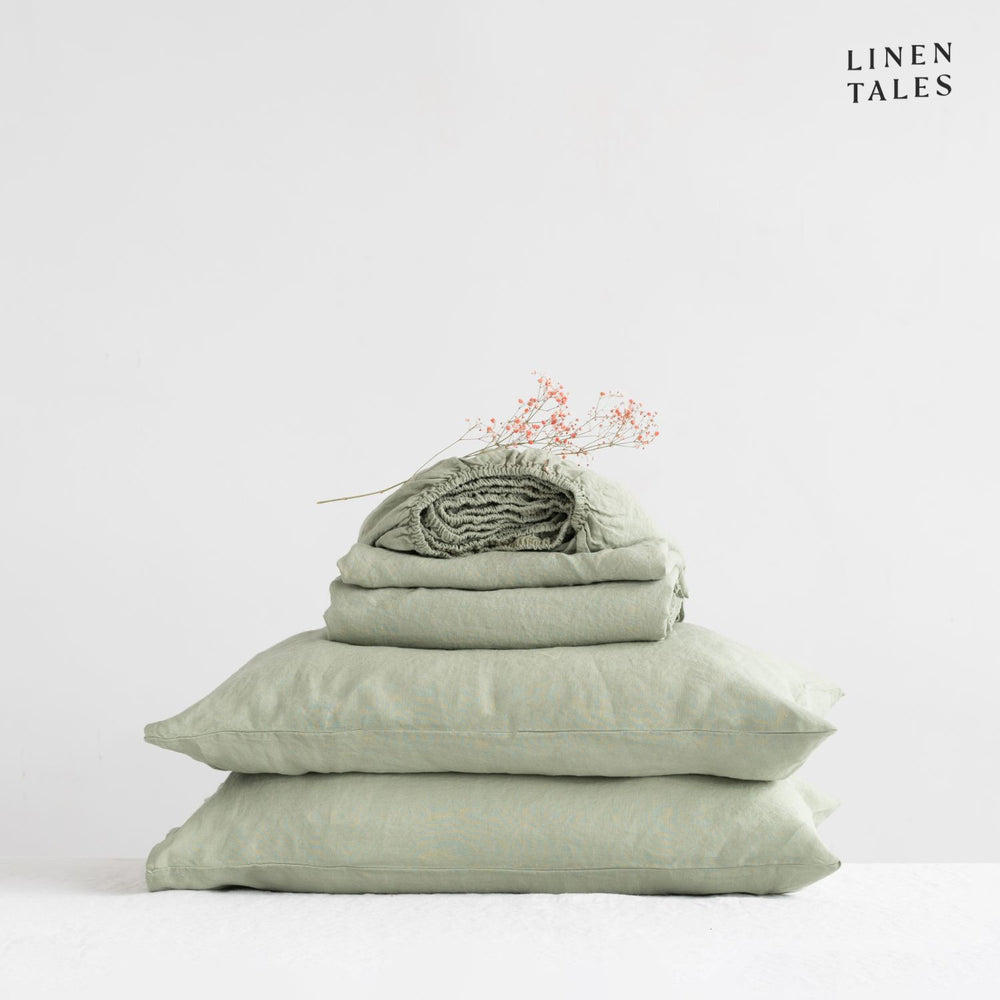 
                  
                    Close-up of 100% linen bedding in Sage, showcasing the soft texture of the flat sheet, fitted sheet, and pillowcase – breathable and timeless.
                  
                