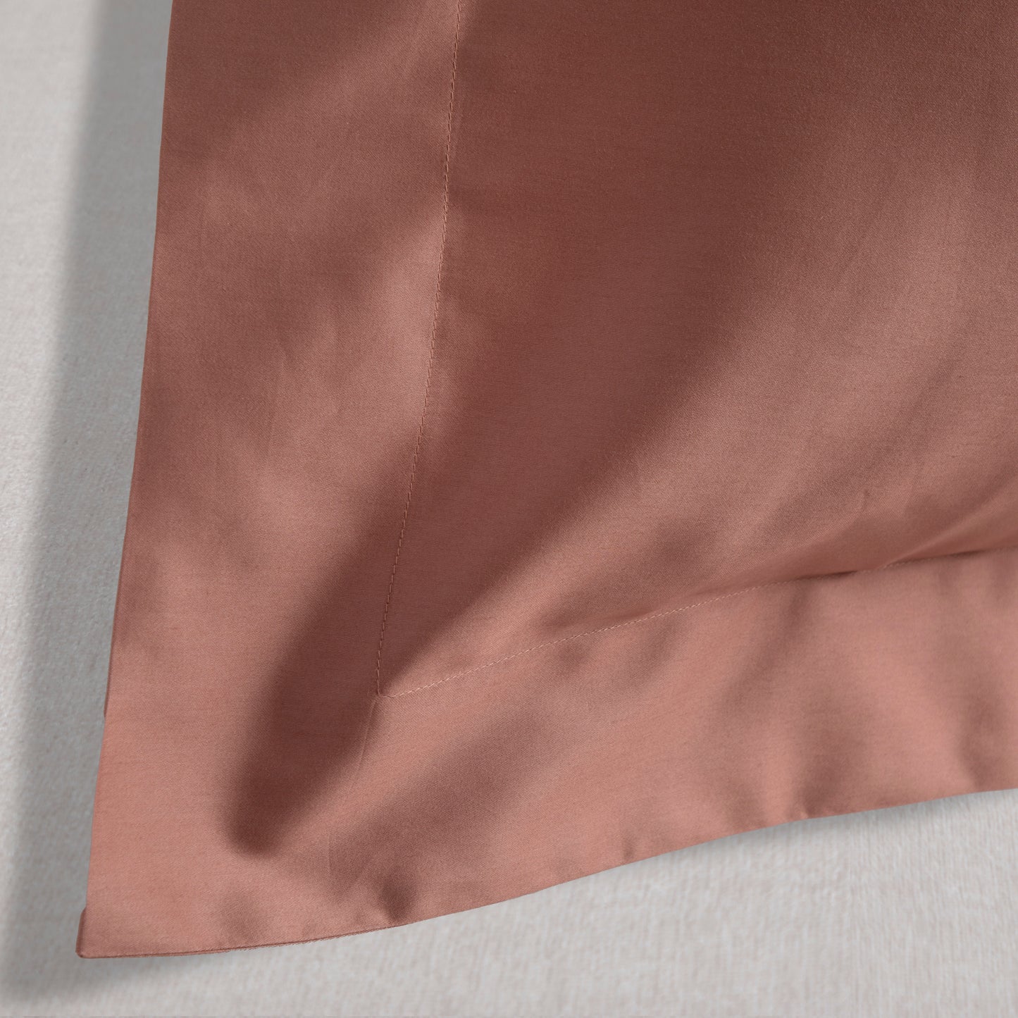 Close-up of dune shadow oxford pillowcase corner on a light gray background – Linen Bay UK