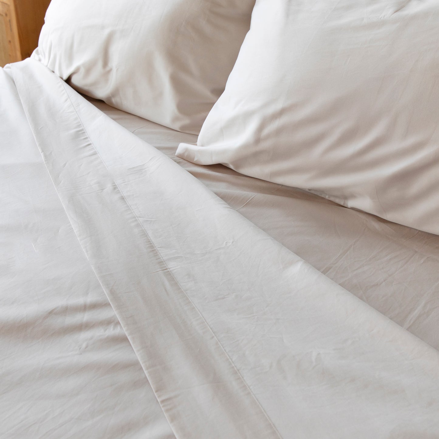 Close-up of driftwood coloured bedding with pillows on a bed – Linen Bay UK