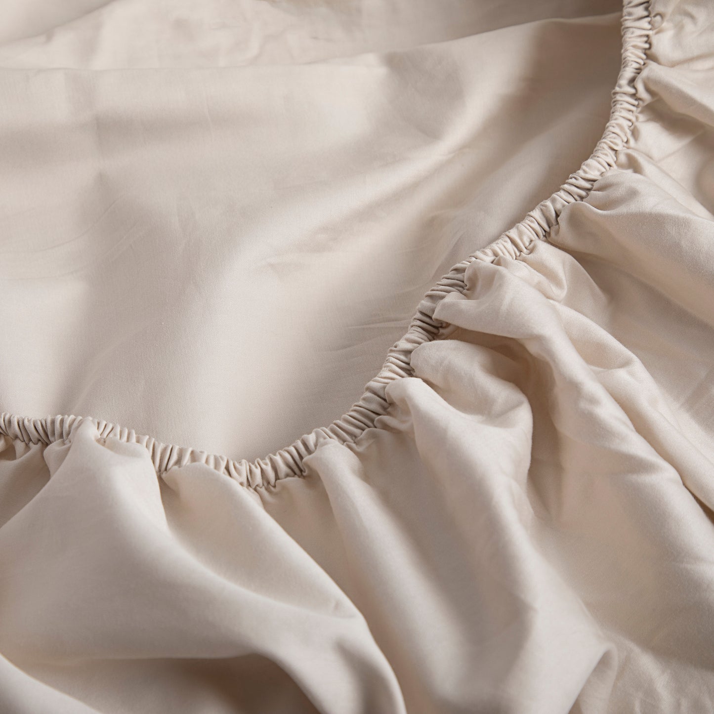 Close-up of a driftwood pure cotton fitted sheet with elastic waistband – Linen Bay UK