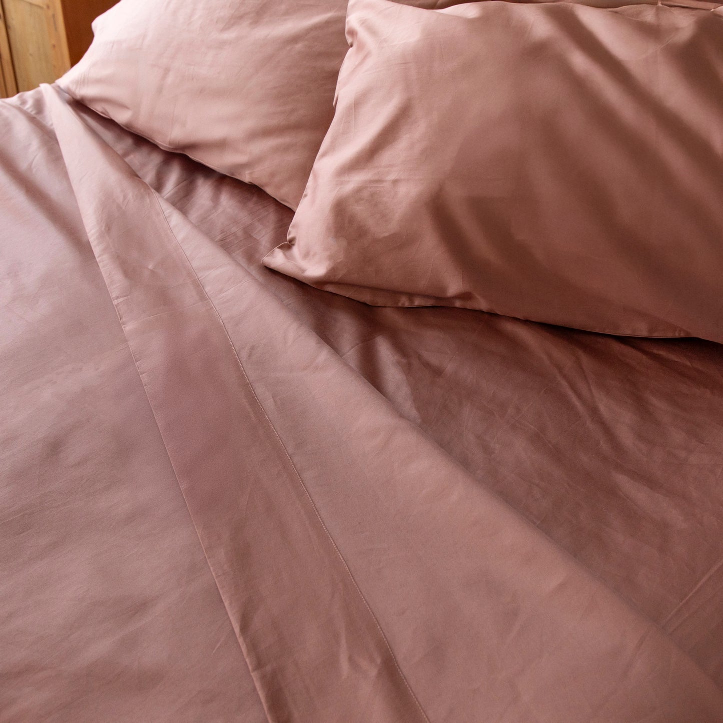 Close-up of dune shadow bedding with pillows on a bed – Linen Bay UK