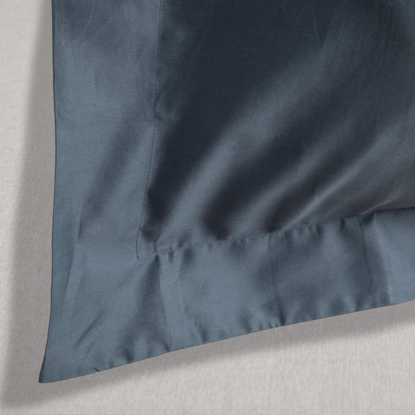 Close-up of a sargasso blue oxford pillow case on a light gray background