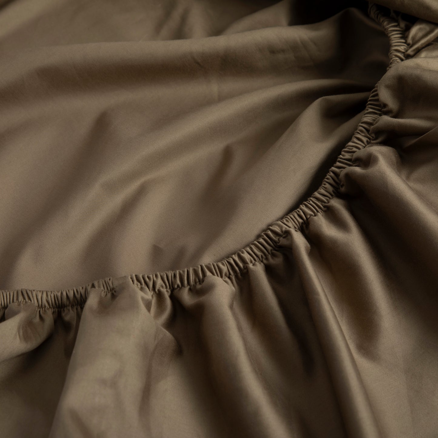 Close-up of sea fern cotton fabric fitted sheet with a textured edge – Linen Bay UK
