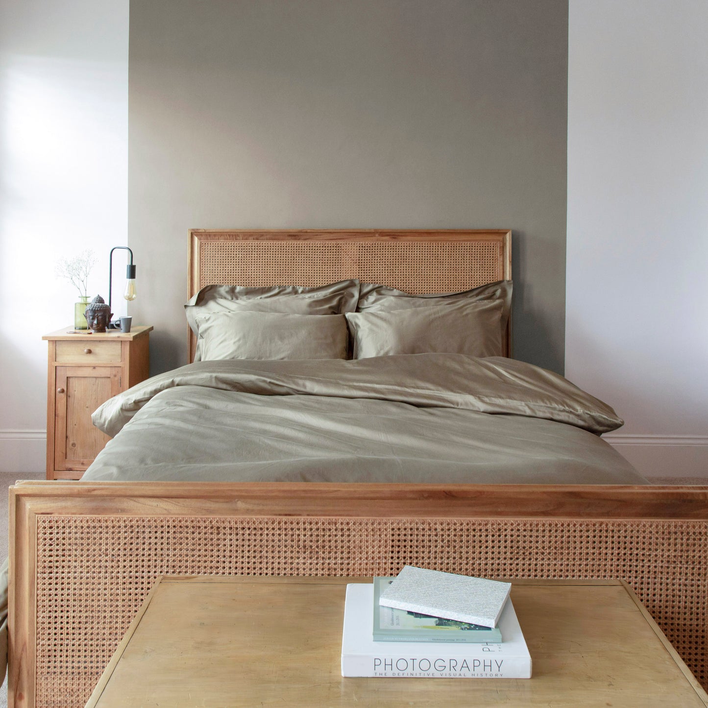 Bedroom with seafern green silky bedding including duvet cover, housewife pillows and oxford pillow slips on a wooden bed with nightstand against a green background – Linen Bay UK