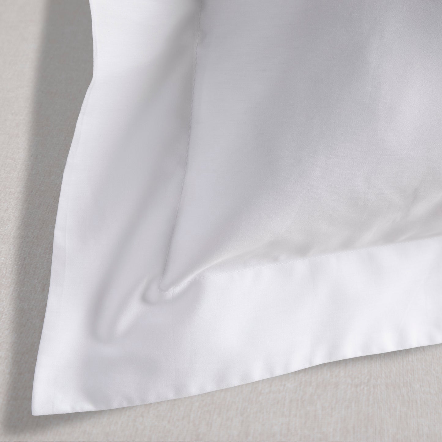 Close-up of a white pillow with a soft texture on a light gray background